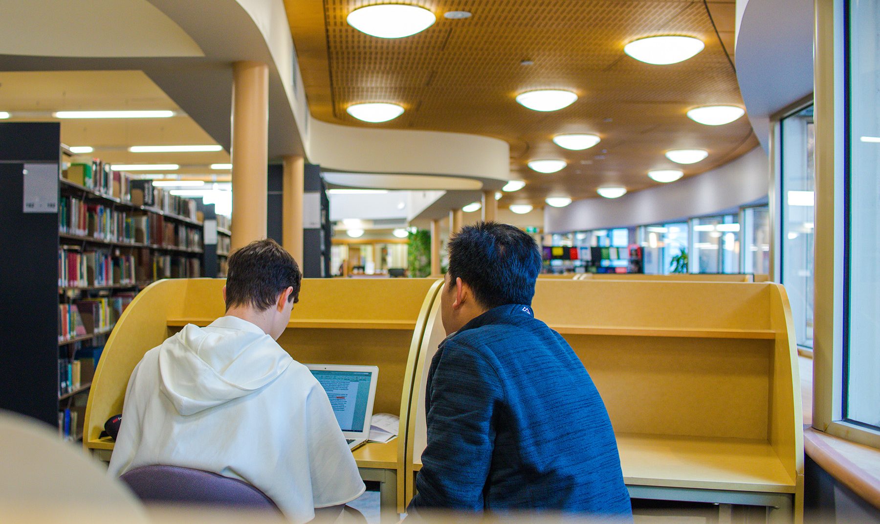 Mannix Library with two students in the study carrells