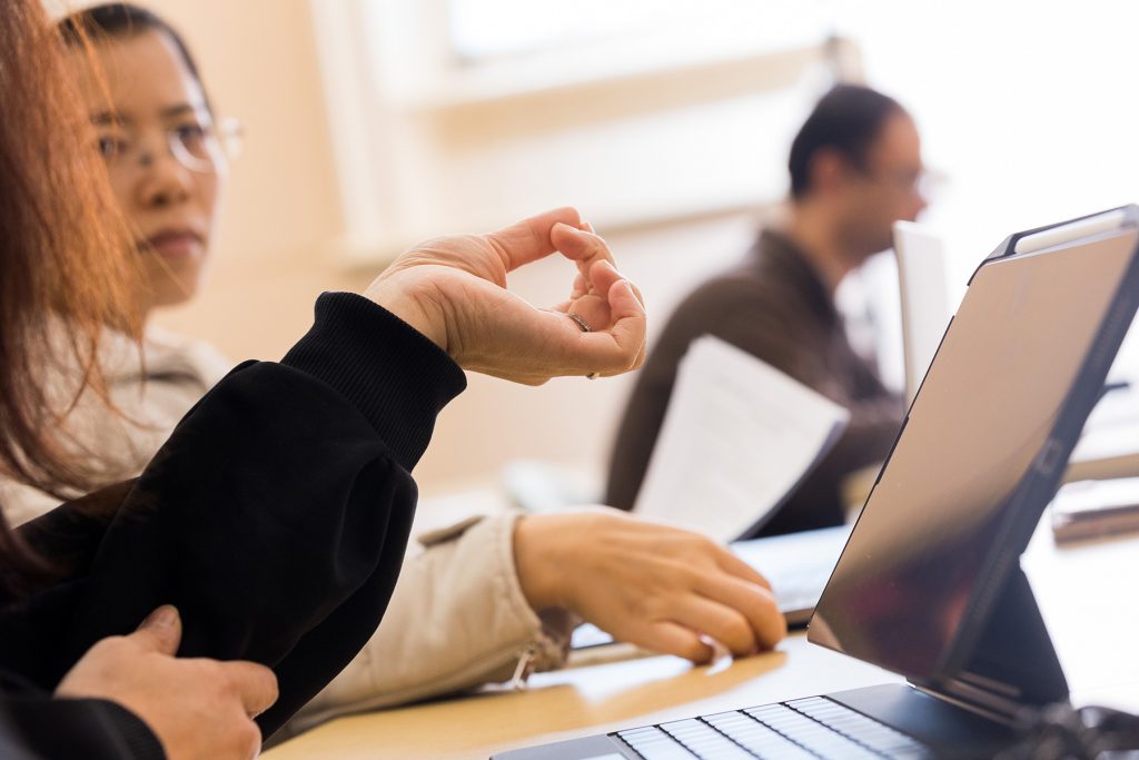 Three students at a desk with a computer in a class at CTC