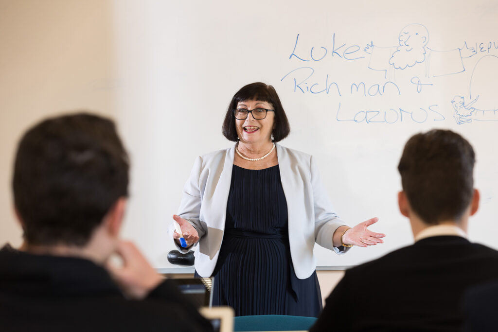 Rosemary Canavan teaches a class in front of a whiteboard.
